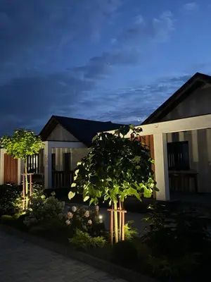 a house with lights in front of it at night at Zator Domki Dreampark in Zator