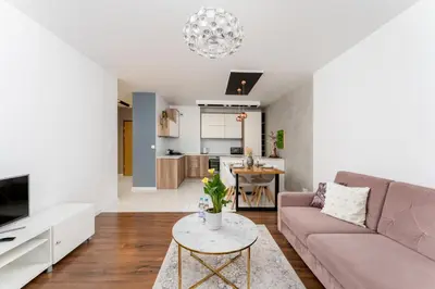 a living room with a couch and a table at Malila Premium Apartments Cracow Cystersów 20D in Kraków