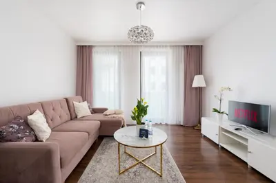 a living room with a couch and a table at Malila Premium Apartments Cracow Cystersów 20D in Kraków