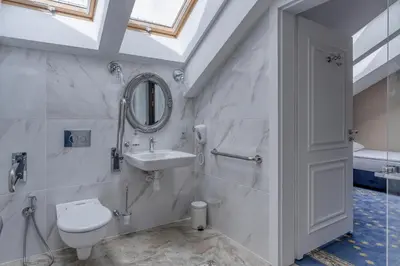 a bathroom with a toilet and a sink and a mirror at Czeczotka Palace Apartments in Kraków
