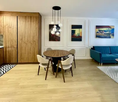 a dining room with a table and chairs and a chandelier at The Velvet Apartment Kościuszki in Kraków