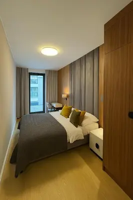 a bedroom with a large bed and a table at The Velvet Apartment Kościuszki in Kraków
