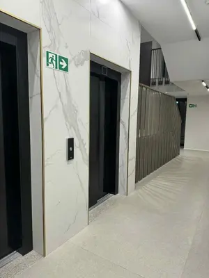 a hallway of an office building with a street sign at The Velvet Apartment Kościuszki in Kraków