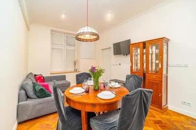 a dining room with a table and chairs at Kazimierz Apt - Top Location - by Rentujemy in Kraków