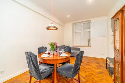 a dining room with a wooden table and chairs at Kazimierz Apt - Top Location - by Rentujemy in Kraków