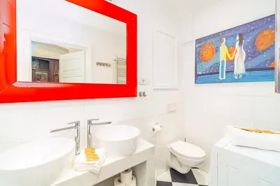 a bathroom with two sinks and a red mirror at Kazimierz Apt - Top Location - by Rentujemy in Kraków
