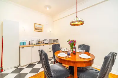 a kitchen and dining room with a wooden table and chairs at Kazimierz Apt - Top Location - by Rentujemy in Kraków