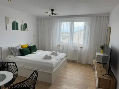 a white bedroom with a bed and a window at KULIG APART - Długa 82 - Kraków Old Town in Kraków
