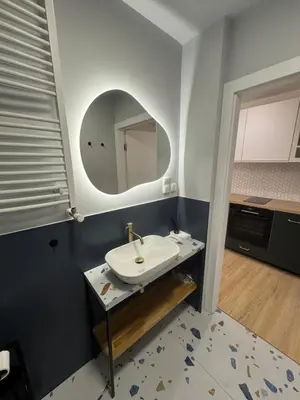 a bathroom with a sink and a mirror at KULIG APART - Długa 82 - Kraków Old Town in Kraków