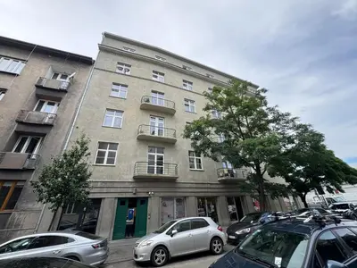 a large building with cars parked in front of it at KULIG APART - Długa 82 - Kraków Old Town in Kraków