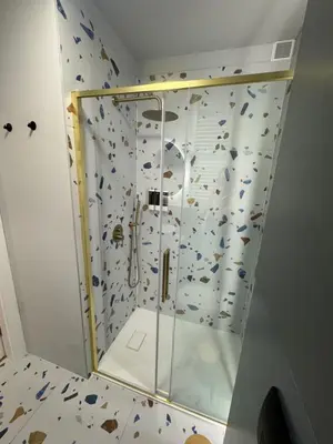 a shower with a glass door in a bathroom at KULIG APART - Długa 82 - Kraków Old Town in Kraków