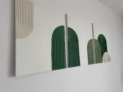 a row of three green paintings on a wall at KULIG APART - Długa 82 - Kraków Old Town in Kraków