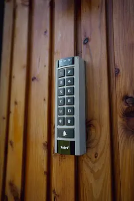 a remote control hanging on a wooden wall at Polana Kasztelana - Beskid Wyspowy in Limanowa