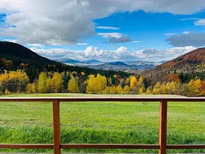 a view from a porch of a field and trees at Polana Kasztelana - Beskid Wyspowy in Limanowa