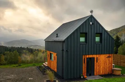 a black house with a gambrel roof at Polana Kasztelana - Beskid Wyspowy in Limanowa
