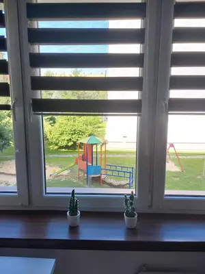 a window with a view of a playground seen through it at Sunny Family Zator Energylandia in Zator