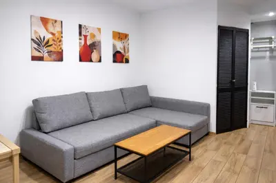a kitchen with white cabinets and stainless steel appliances at Sunny Family Zator Energylandia in Zator
