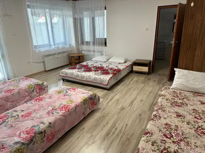 three beds in a room with wooden floors at HOTEL&RESTAURACJA DALLAS LuxUSAPL - 2026 NOWA WŁAŚCICIELKA ZAPRASZA!! in Myślenice