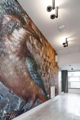 a large mural of a bird on a wall at Househost Apartment Miodowa 42 20 in Kraków