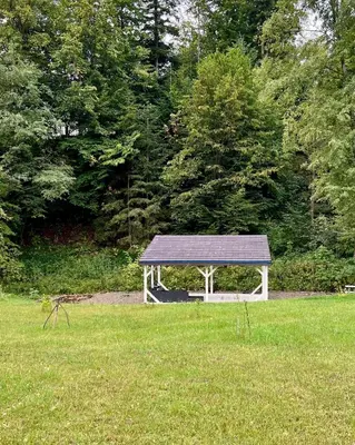 a bench in the middle of a grass field at Jaśminowa Pracownia in Rupniów