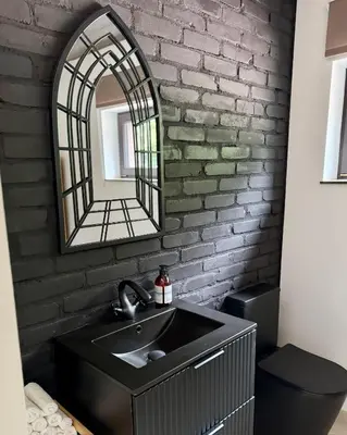 a bathroom with a sink and a mirror at Jaśminowa Pracownia in Rupniów