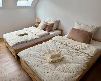two twin beds in a room with at Jaśminowa Pracownia in Rupniów