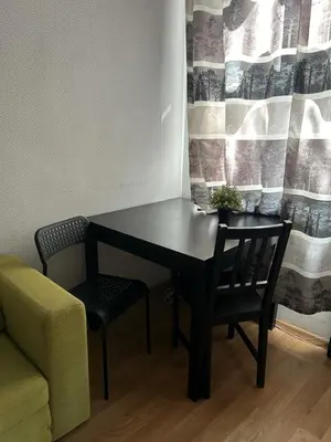 a black table with two chairs and a plant on it at Hala Targowa Apartament in Kraków