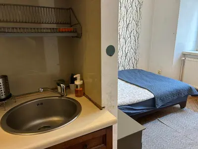 a bathroom with a sink and a bed in a room at Planty Apartament in Kraków