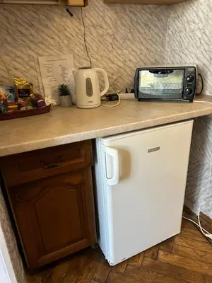 a kitchen counter with a toaster and a microwave on it at Planty Apartament in Kraków