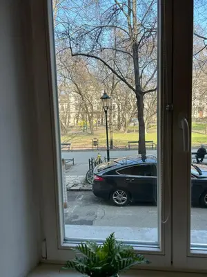 a view of a car parked outside a window at Planty Apartament in Kraków