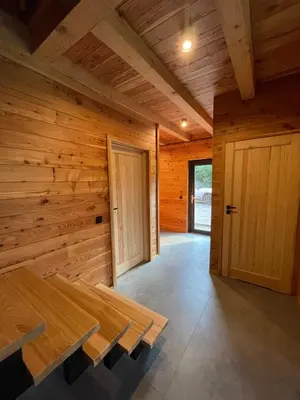 a wooden room with a table and a door at Chałpy H700 in Koszarawa