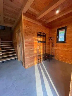 a room with wooden walls and stairs in a cabin at Chałpy H700 in Koszarawa