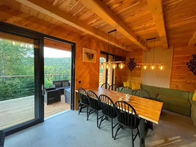 a dining room with a table and chairs at Chałpy H700 in Koszarawa