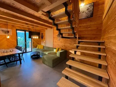 a living room with a staircase in a house at Chałpy H700 in Koszarawa