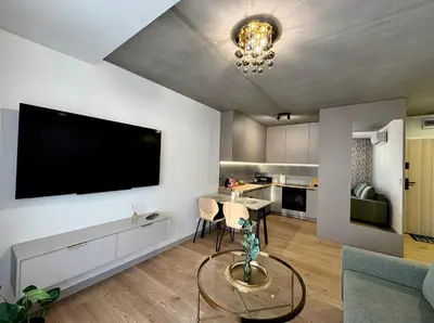 a living room with a large flat screen tv on the wall at Piast Apartment - free parking in Kraków