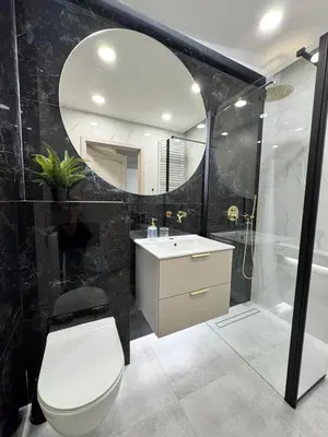 a bathroom with a toilet and a sink and a mirror at Piast Apartment - free parking in Kraków