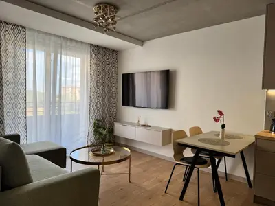 a living room with a couch and a table at Piast Apartment - free parking in Kraków