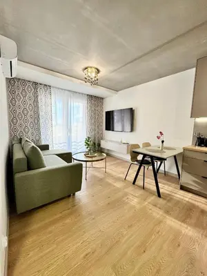 a living room with a couch and a table at Piast Apartment - free parking in Kraków