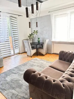 a living room with a couch and a table at Mateczny in Kraków