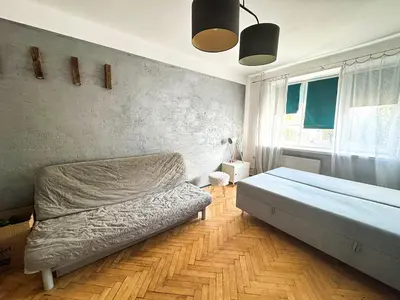 a bedroom with a bed and a wall at Mateczny in Kraków