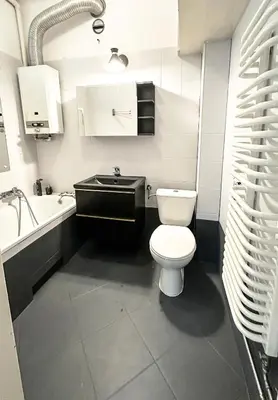a bathroom with a toilet and a sink and a tub at Mateczny in Kraków