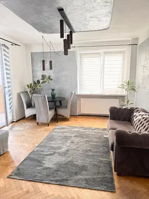 a living room with a couch and a table at Mateczny in Kraków