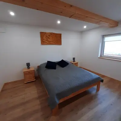 a bedroom with a bed in a room with a window at Domek pod Skiełkiem in Łukowica