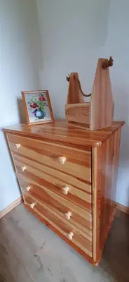 a wooden dresser with a picture on top of it at Domek pod Skiełkiem in Łukowica
