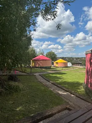 a group of buildings in a field of grass at Brzozowy Zagajnik in Inwałd