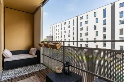 a balcony with a bench and a building at Apartament Bonarka-Podgórze in Kraków