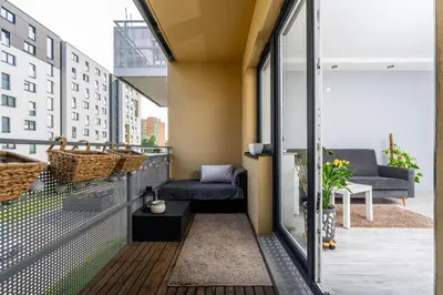 a balcony with a couch and a chair at Apartament Bonarka-Podgórze in Kraków