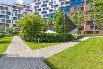 a walkway in a park in front of a building at Bright Apartment in Cracow Center with Terrace, Desk and Bathtub by Noclegi Renters in Kraków