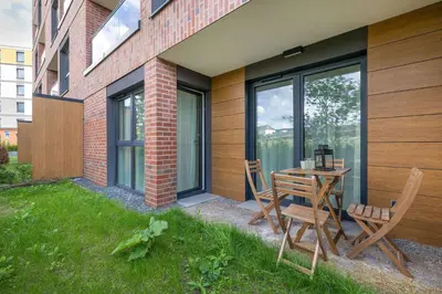 a patio with a table and chairs next to a building at Bright Apartment in Cracow Center with Terrace, Desk and Bathtub by Noclegi Renters in Kraków