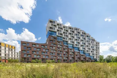 a tall building with blue windows on the side of it at Bright Apartment in Cracow Center with Terrace, Desk and Bathtub by Noclegi Renters in Kraków